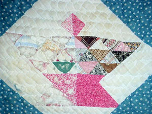 Picture of a restored quilt. Before shows that the quilt was faded. After restoration, the quilt is bright and beautiful.